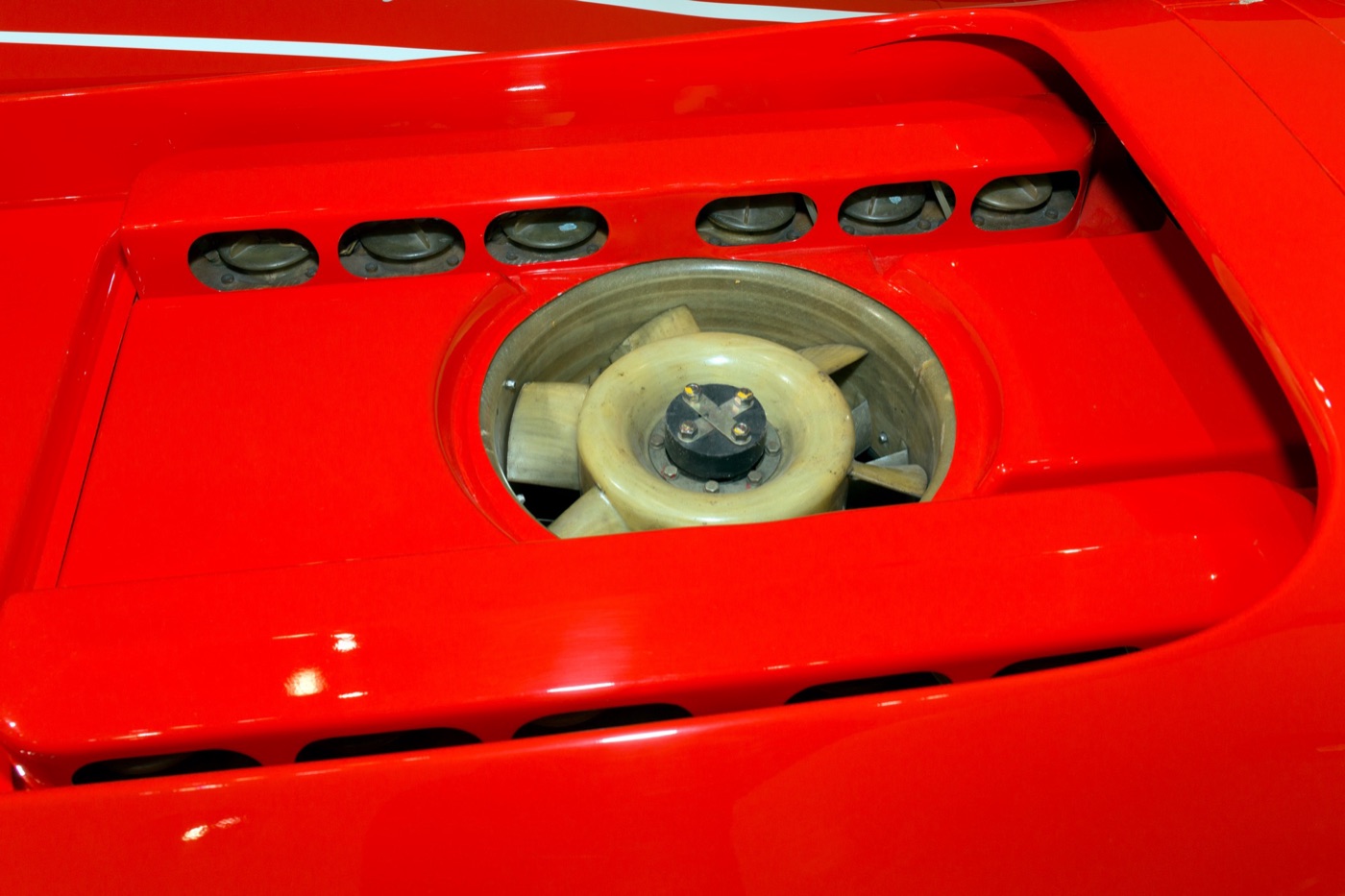 Horizontal cooling fan of the Porsche 917 flat-twelve engine seen through the red rear bodywork