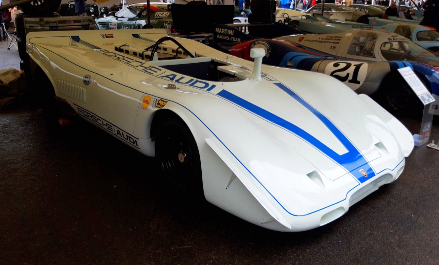 White open Porsche 917 PA Spyder with a blue stripe over the nose in a display tent