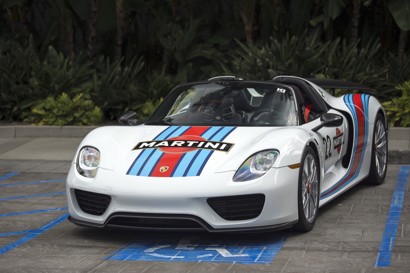 White Porsche 918 Spyder in Martini Racing livery with number 22, parked with the roof panels out