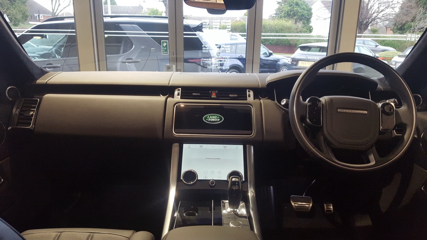 Dashboard of a 2018 Range Rover Sport Autobiography with two stacked touchscreens and a right-hand-drive steering wheel