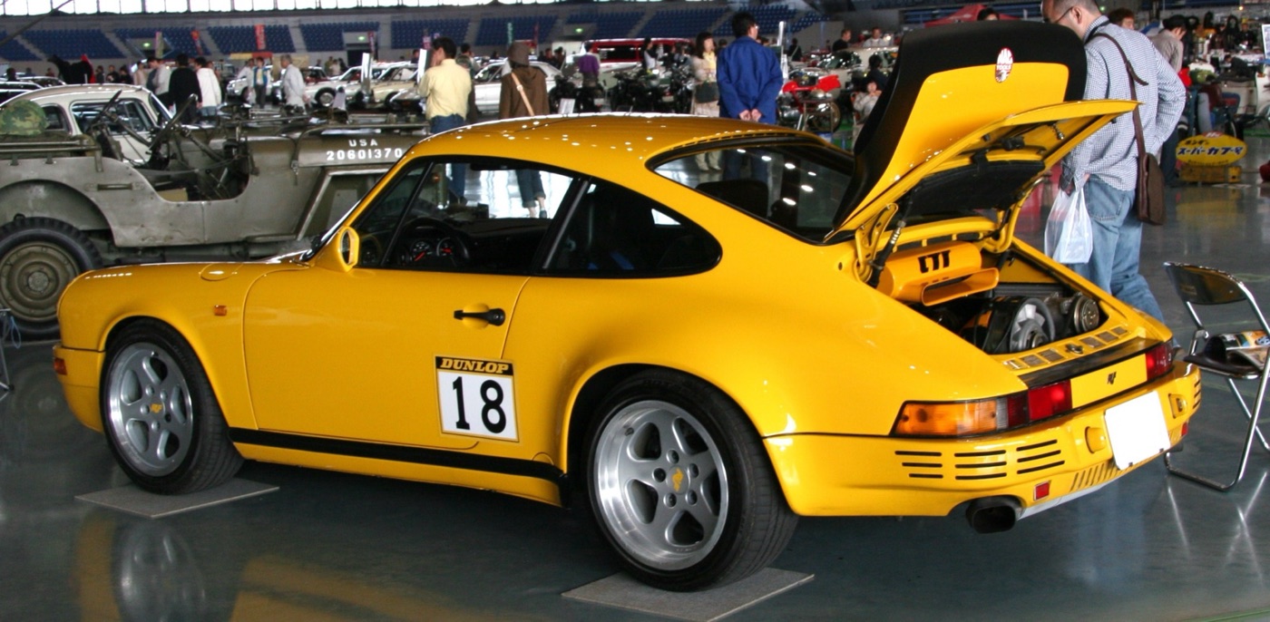 Yellow Ruf CTR Yellowbird from the rear three-quarter with its engine lid and rear wing raised