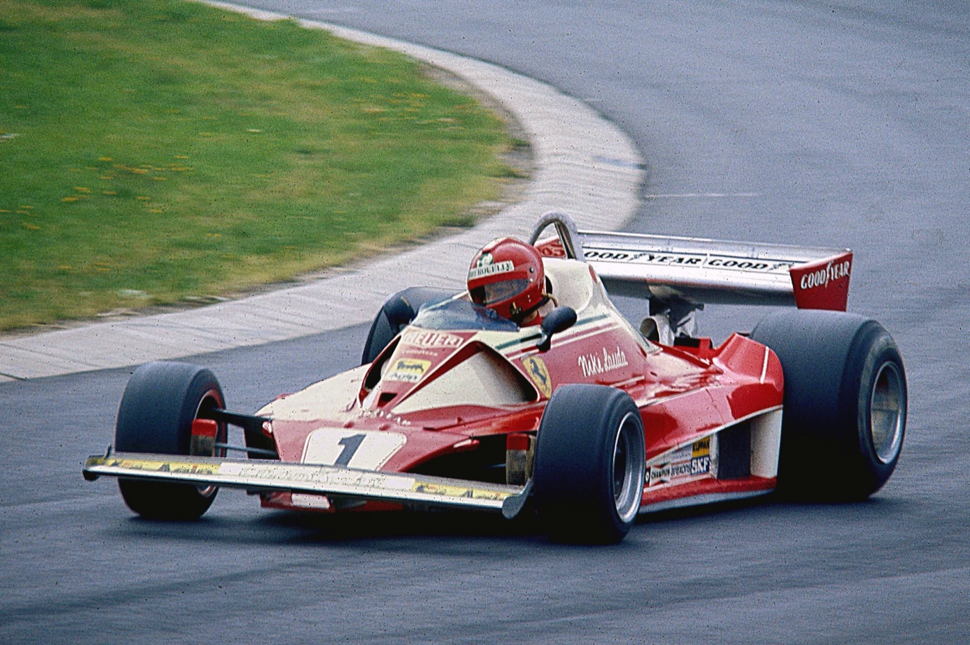 Niki Lauda in the red and white number 1 Ferrari 312T2 cornering at the Nürburgring