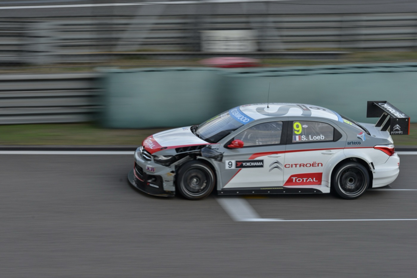 White and grey Citroën C-Elysée WTCC touring car, number 9, with damaged front bodywork on the Shanghai circuit