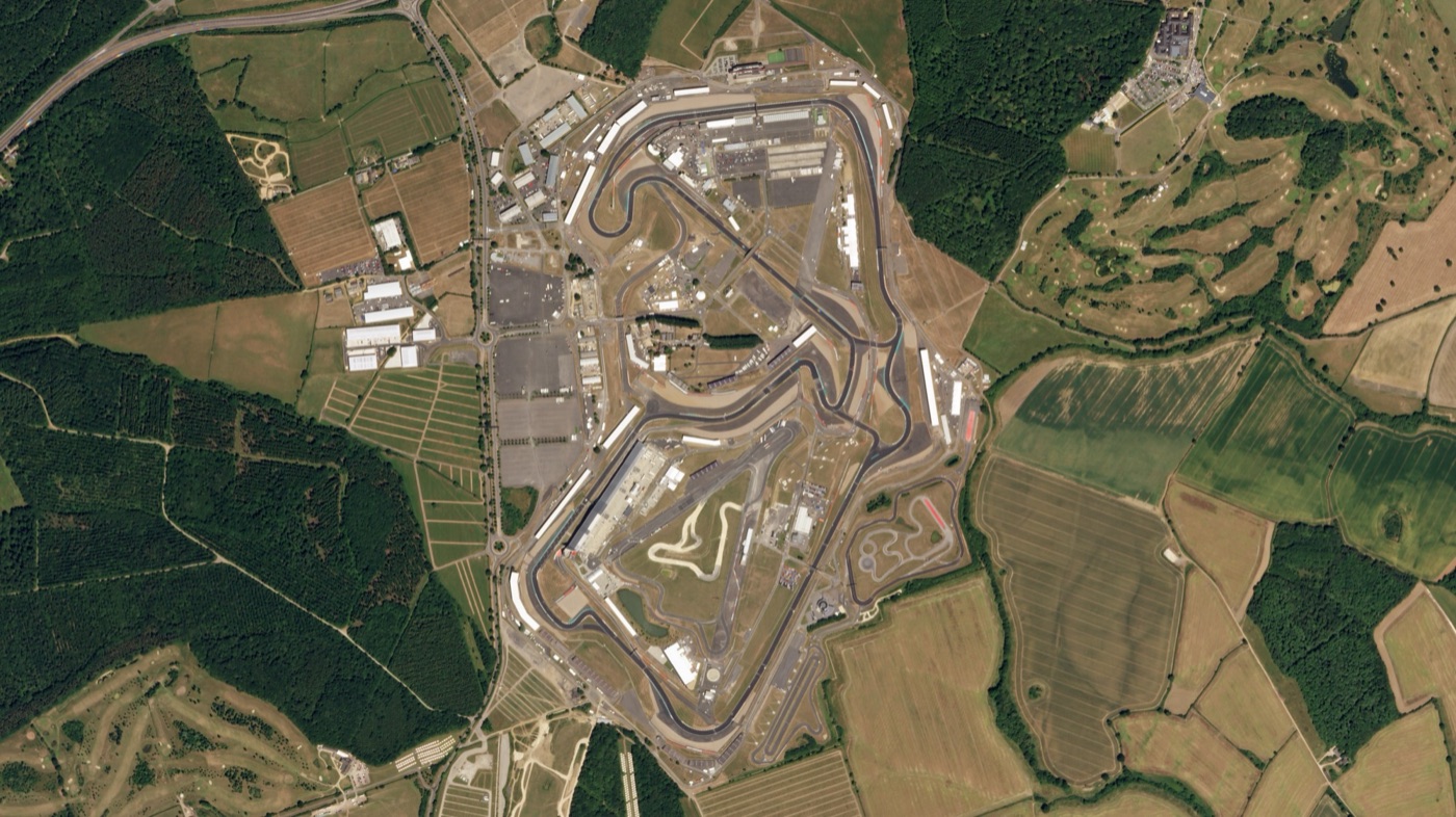Satellite view of Silverstone Circuit and the fields and woods around it, July 2018