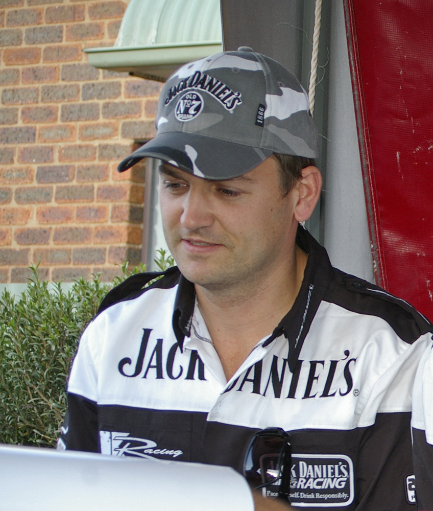 Ben Collins in a grey camouflage cap and a black and white team shirt