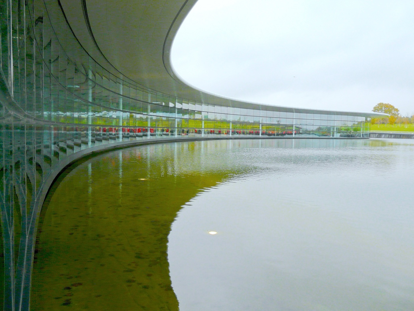 The McLaren Technology Centre in Woking, the glass headquarters where McLaren Tooned is set, curving round its lake