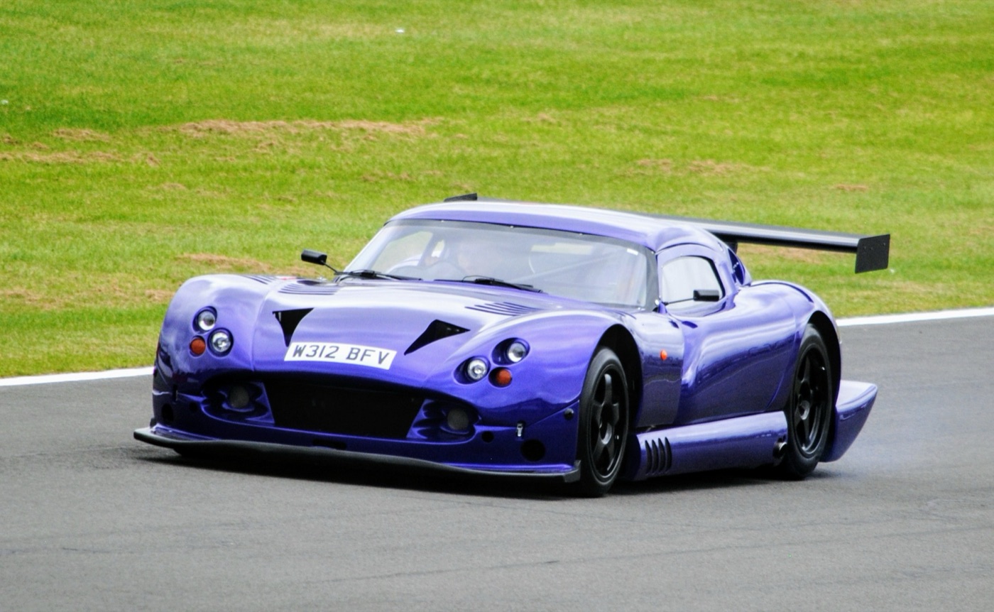 Purple TVR Cerbera Speed 12 racing coupé with a large rear wing on track at Donington Park