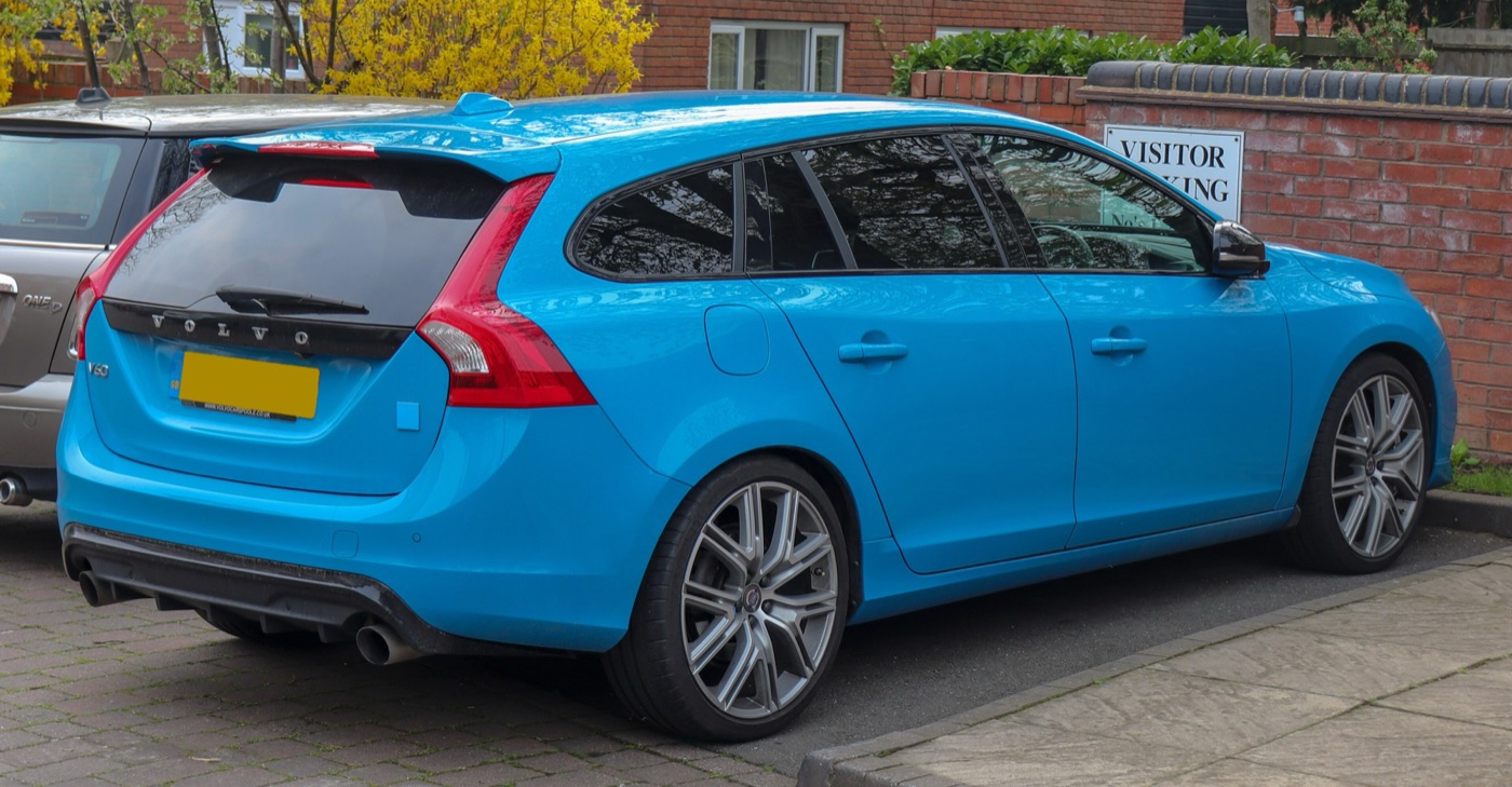 Rebel Blue 2016 Volvo V60 Polestar 2.0 seen from the rear three-quarter, showing the diffuser, twin tailpipes and roof spoiler