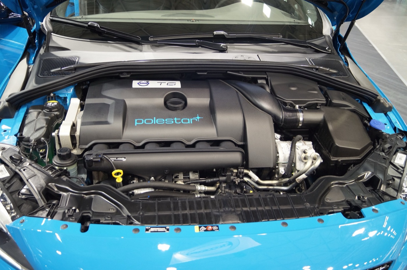 Engine bay of a Rebel Blue Volvo S60 Polestar with a Polestar-badged T6 engine cover