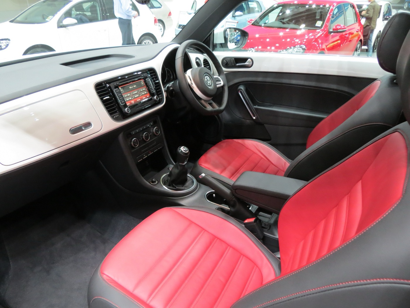 Right-hand-drive Volkswagen Beetle A5 cabin with a white body-coloured dashboard and red leather seats