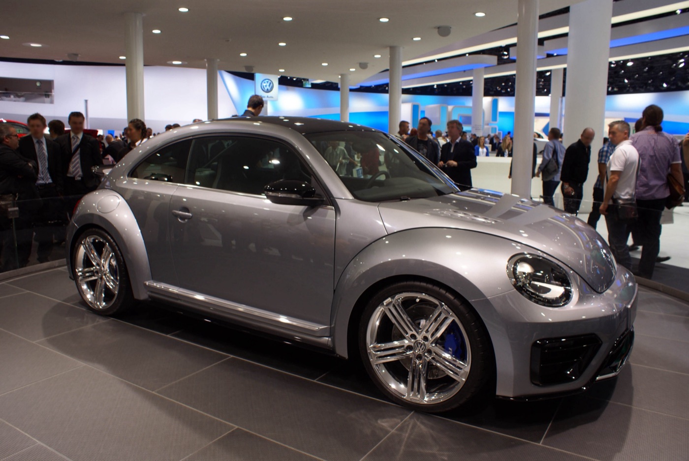 Silver-grey Volkswagen Beetle R concept with large chrome five-spoke wheels on a motor show stand