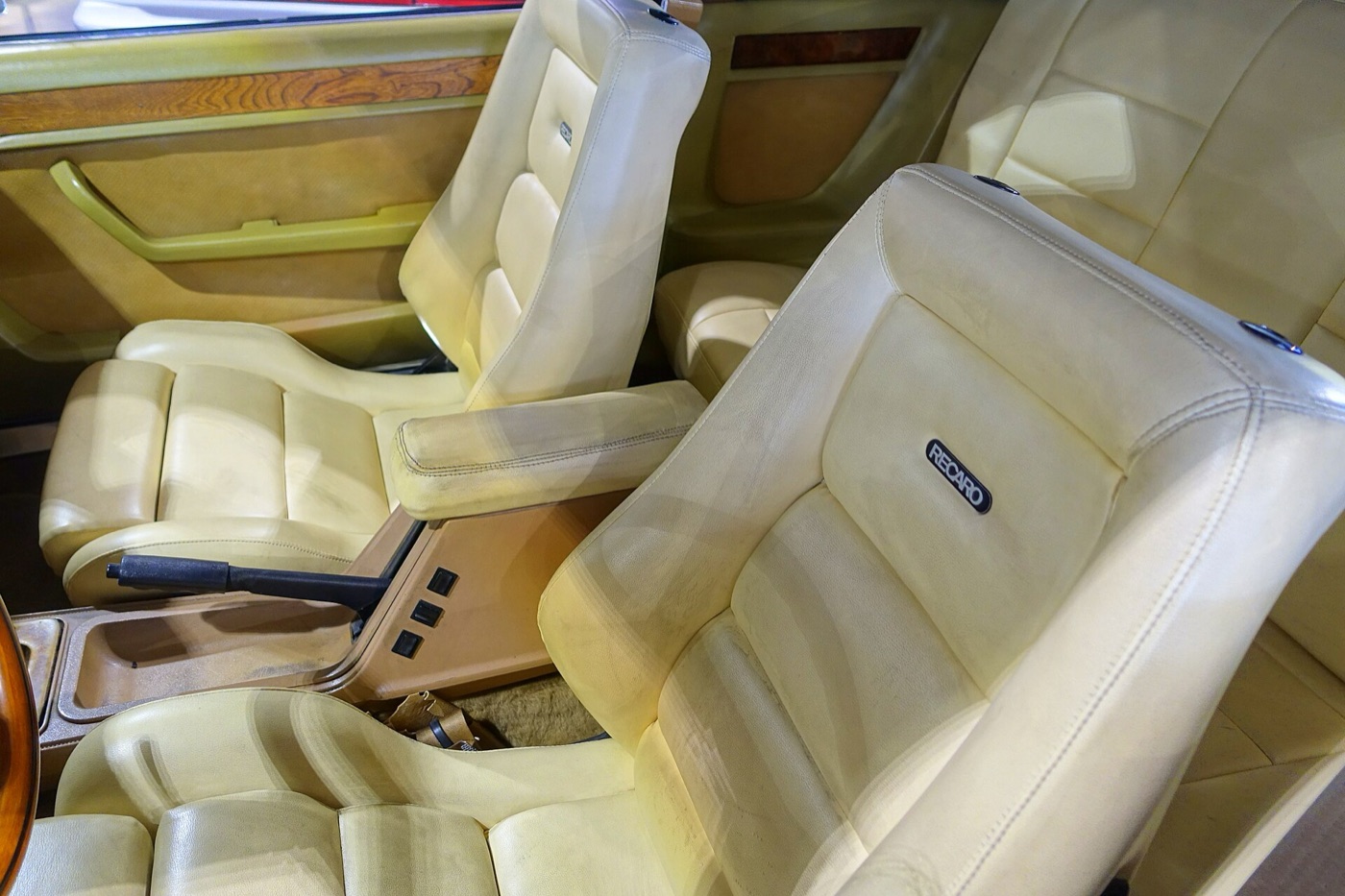 Cream leather Recaro seats and wood-trimmed door panels inside a Zimmer Golden Spirit